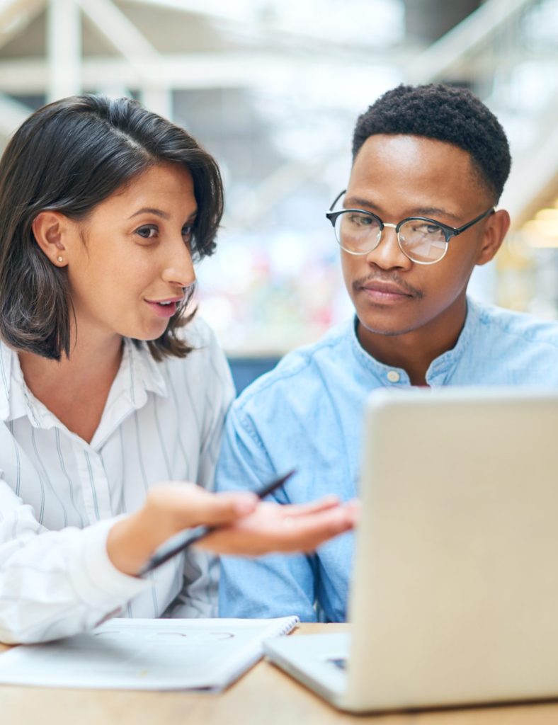 Laptop, team and business people training, help or coaching with mentor or manager. Collaboration, diversity or workers in discussion for information with creative editor in startup office internship